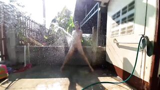 GARDEN SHOWER AND WATER RUBS INTO RURAL GARDEN a Man