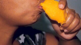 Hottie mouth black having fun with a mango