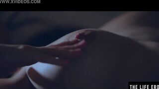 Rubbing her big puffy nipples as she fucks herself with