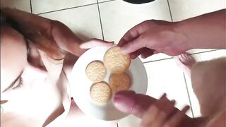 Bitch eats snack that is topped with cum after she