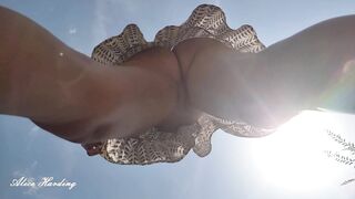 Alice inside Nature without Lingerie Upskirt Shows her Snatch by Putting the Camera into the Grass