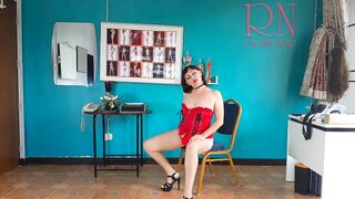 An elegant lady employee inside red underwear undresses inside the