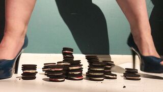 Beauty women inside Heels Crushes and Plays with Cookies