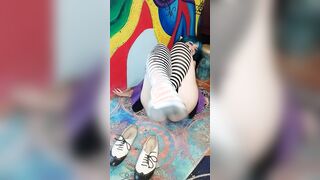 Elf chick takes off shoes and thigh highs