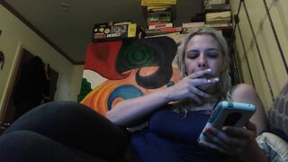 Beauty blonde smokes clove cigarettes, plays on phone and plays with hooters