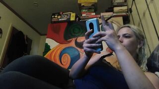 Beauty blonde smokes clove cigarettes, plays on phone and plays with hooters
