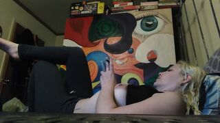 Beauty blonde smokes clove cigarettes, plays on phone and plays with hooters