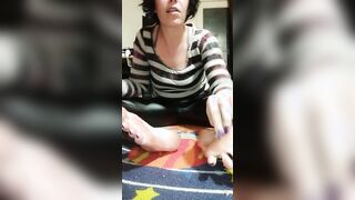 Ferralyn strokes coconut oil on her toes
