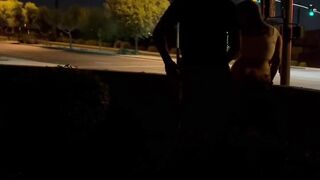 Sex inside an intersection with cars driving by.