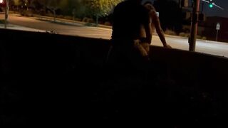 Sex inside an intersection with cars driving by.