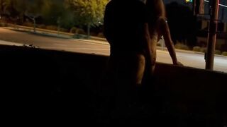 Sex inside an intersection with cars driving by.