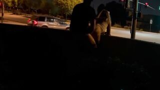 Sex inside an intersection with cars driving by.