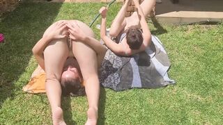 Half nude girls having fun with a garden hose