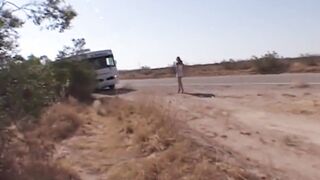 She stands inside the dessert and stop a bus -