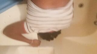 Bent over inside the bath-tub
