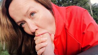 Turned On dark hair giving oral sex to long penis inside red raincoat