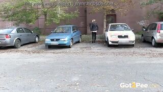 Squatting Between Parked Cars To Piss Into Outside