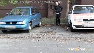 Squatting Between Parked Cars To Piss Into Outside