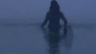 Hispanic mom Takes an Evening Beach Stroll