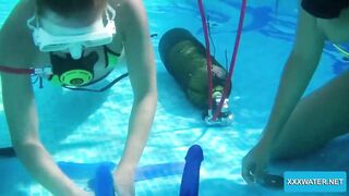 Underwater lesbians lick and suck dildos