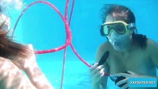 Underwater lesbians lick and suck dildos