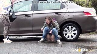 Blonde And Dark Hair Squat And Piss Together