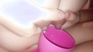 Young mother pours milk inside a cup