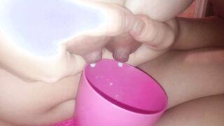 Young mother pours milk inside a cup
