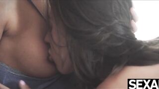 View this Beauty dark haired suck her lesbian lover's big natural boobies