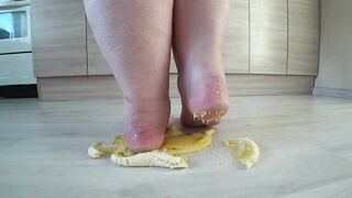 a long mature woman, bbw, smash a banana with bare feet, heels.