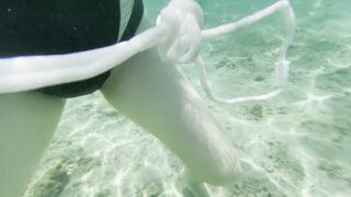 Jolie femme à la plage publique me montre sa chatte et ses seins dans l'eau