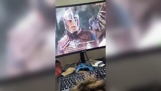 Trying to keep quite while he plays his movie game!