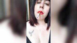 She smokes and moves provocatively inside the WC while changing clothes