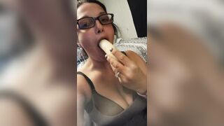 Candy licking and blowing a banana