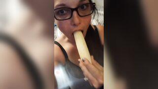 Candy licking and blowing a banana