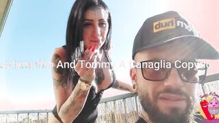 She smokes and he into overalls on the balcony