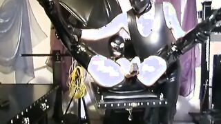 The soak vagina of a pvc women is penetrated by her master with a vibrator - Part one