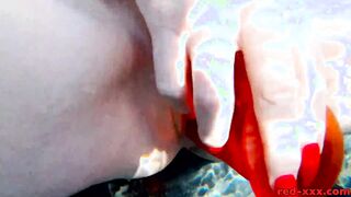 Red XXX fucks her cunt with a sex toy into the pool