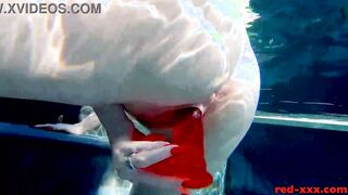 Red XXX fucks her cunt with a sex toy into the pool