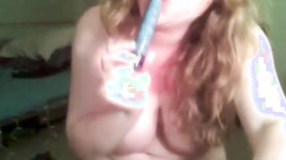 Redhead with big juggs helps herself out with blue dildo