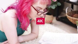 Attractive cunt with mouth with glasses is lying on the floor and writing something