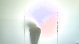 Alexis Brill hoses herself off in the pool shower before carefully stepping to the changing room where she puts on