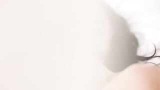Turned On Megan Rain lays on the bed in just a pair of underwear, caressing her small titties and rubbing her