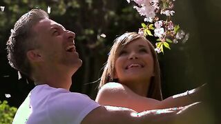 Angel Piaff and Lutro enjoy a sweet moment outdoor beneath the blossoms of a cherry tree. Their laughter turns to