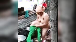 an outdoor wash of a rural Indian mom
