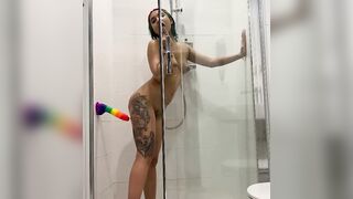 Inked chick riding a dildo inside the shower