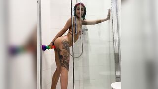 Inked chick riding a dildo inside the shower