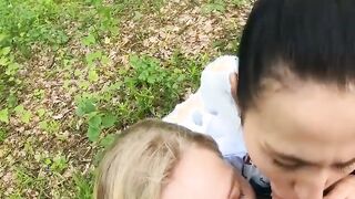 Two Girlfriends Suck Cock in the Wood