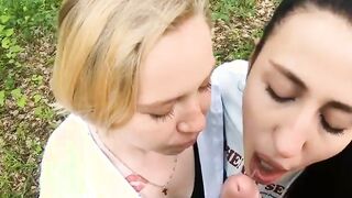 Two Girlfriends Suck Cock in the Wood