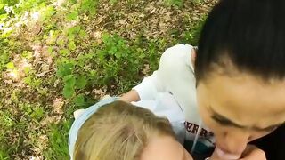 Two Girlfriends Suck Cock in the Wood